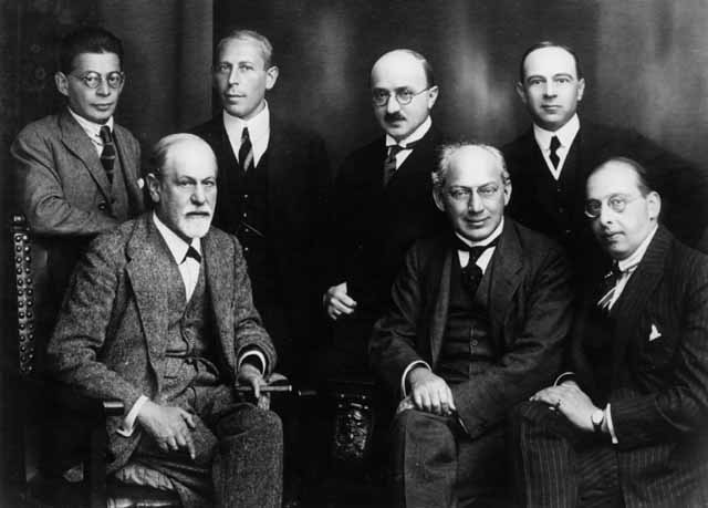 Left to right, seated: Sigmund Freud, Sándor Ferenczi, and Hanns Sachs. Standing; Otto Rank, Karl Abraham, Max Eitingon, and Ernest Jones. Photo 1922